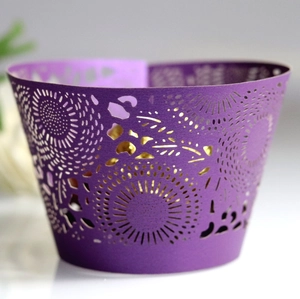 Purple laser-cut cupcake wrappers with sunburst patterns and golden inner layer