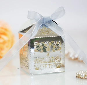 Laser-cut silver deer favor box with a blue satin ribbon and intricate forest silhouettes