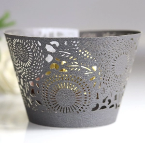 Silver laser-cut lace cupcake wrappers with intricate hollow sun patterns for weddings