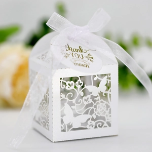 Detailed laser-cut white wedding gift box with butterfly patterns and silk ribbon
