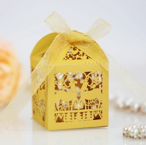 Detailed laser-cut gift box featuring reindeer and trees with a yellow ribbon bow