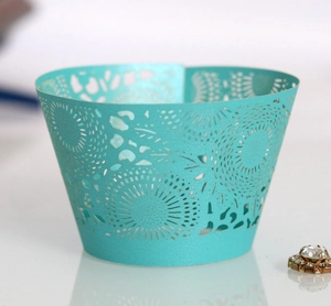 Detailed laser-cut pattern on mint green cupcake wrappers for elegant dessert decor