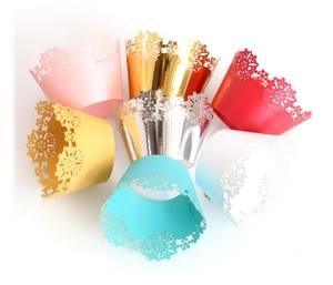 Laser cut snowflake Christmas cupcake wrappers in various metallic colors for party decor