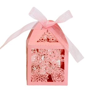 Detailed laser-cut floral pattern on pink wedding gift box with matching silk ribbon