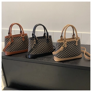 Three Boston style handbags in brown, black, and beige with geometric dot pattern texture