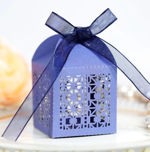 Lilac laser-cut wedding favor box with pearl finish and blue organza ribbon