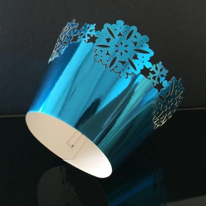 Metallic blue laser-cut cupcake wrappers with snowflake design for Christmas parties