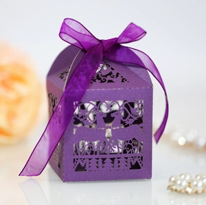 Detailed macro view of a purple laser-cut gift box with forest deer patterns and silk ribbon