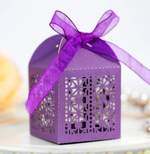 Detail of purple laser cut gift box with geometric patterns and matching silk ribbon bow