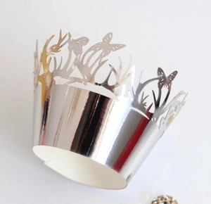 Silver laser-cut cupcake wrappers featuring detailed butterfly and deer horn patterns