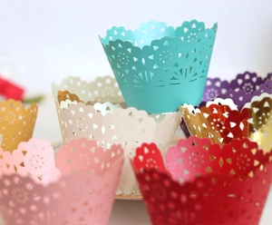 Laser-cut lace cupcake wrappers in multiple colors for festive dessert table decoration