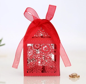 Detailed laser-cut floral wedding favor box in red cardstock with organza ribbon bow