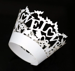Macro detail of laser-cut LOVE heart cupcake wrapper for wedding party decoration