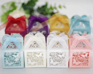 Macro view of laser-cut butterfly gift boxes with elegant ribbon bows in multiple colors