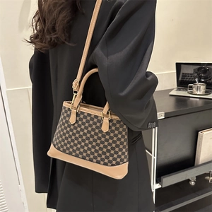 Retro plaid crossbody handbag with adjustable shoulder strap shown in a lifestyle scene