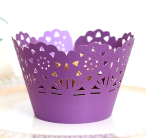 Close-up of laser-cut purple cupcake wrapper with intricate geometric lace flower pattern
