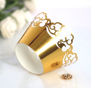 Golden laser cut cupcake wrappers with cloud patterns for festive party decorations