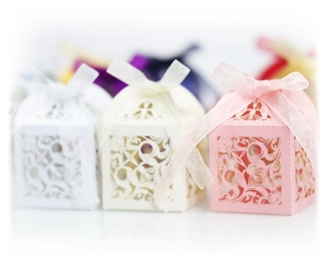 Boîtes à bonbons mariage découpées au laser avec motifs floraux et nœuds en ruban