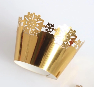 Golden laser-cut snowflake cupcake wrappers with a metallic mirror finish for holiday decor