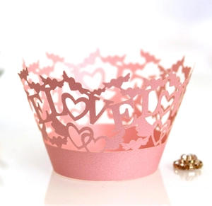 Pink laser-cut cupcake wrappers with LOVE and heart patterns for wedding party decor