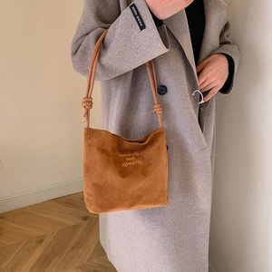 Brown suede tote bag with onwards and upwards embroidery and knotted strap design