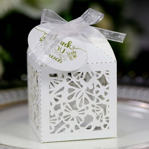 Detailed laser-cut butterfly gift box with white ribbon and Thank You tag on a plate