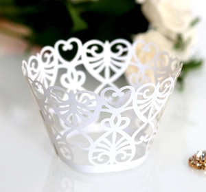 Elegant white laser-cut cupcake wrappers with heart lace design for weddings