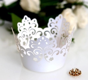 White laser-cut crown muffin cup wrap with intricate floral patterns for wedding decor