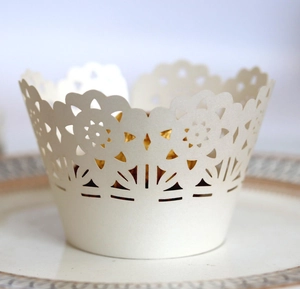 Elegant laser cut white lace cupcake wrapper with intricate floral hollow design