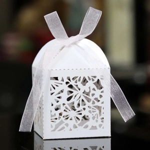 Elegant white laser-cut wedding favor box with butterfly patterns and silk ribbon