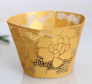 Detail showing the intricate laser-cut floral pattern of the golden cupcake wrapper
