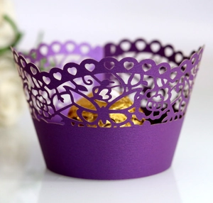 Close-up of laser-cut purple cupcake wrapper featuring butterfly and floral patterns
