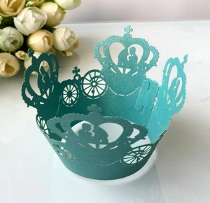 Detailed laser cut tiffany blue cupcake wrappers with pumpkin carriage and crown patterns
