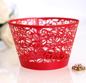 Macro shot of red laser-cut lace cupcake wrappers with elegant floral hollow out patterns