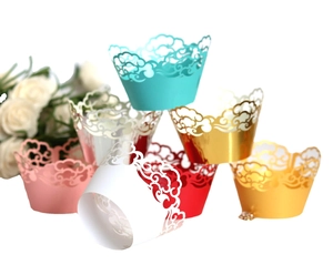 Laser cut lace cupcake wrappers in various colors for wedding and party decorations