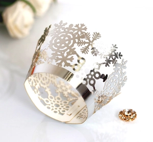 Elegant silver laser-cut snowflake cupcake wrappers for festive Christmas table decoration