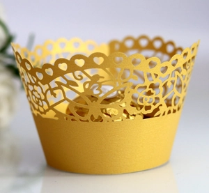Gold laser-cut cupcake wrapper with heart and rose patterns for festive table decor