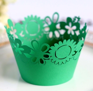 Laser-cut emerald green sunflower cupcake wrappers for elegant party dessert styling