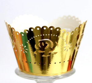 Detailed laser-cut golden rose pattern cupcake wrappers with scalloped edges for weddings