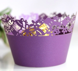 Purple laser-cut cupcake wrapper with elegant floral and butterfly hollow patterns