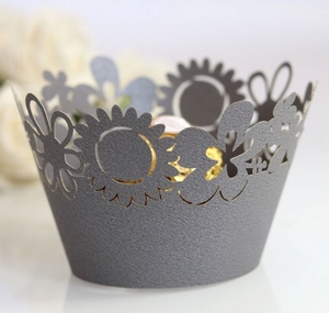 Macro detail of sky blue laser-cut sunflower cupcake wrapper with pearl paper texture