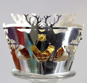 Silver laser-cut Christmas reindeer cupcake wrappers with shimmering metallic pearl paper