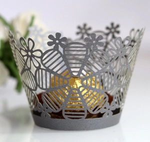 Silver laser-cut lace cupcake wrapper with intricate floral patterns and pearlescent finish