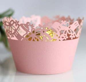 Laser cut light pink floral cupcake wrappers with intricate bird and lace patterns