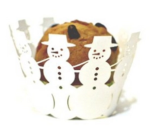 Detail of laser-cut white snowman cupcake wrapper with intricate holiday patterns