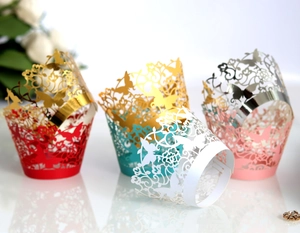 Detailed laser-cut cupcake wrappers with elegant butterfly and floral patterns in four colors