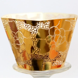 Elegant gold hollow cupcake wrapper with intricate honeycomb laser cut patterns