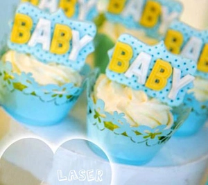 Detail of light blue laser-cut cupcake wrappers with intricate floral hollow design