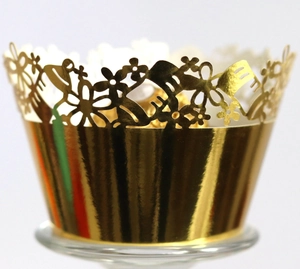 Golden laser-cut hollow cupcake wrappers with elegant floral lace for party decoration