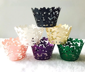 Detail of laser-cut cupcake wrappers in six colors with heart patterns for wedding decor